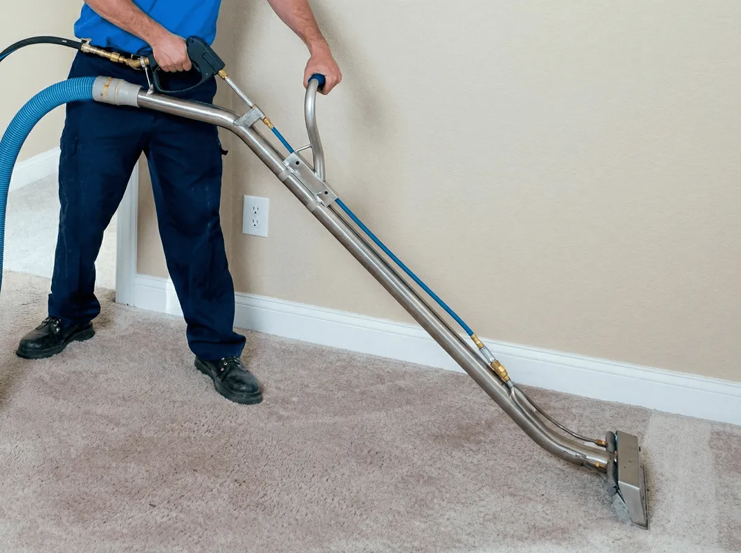 Professional operating a liquid removal machine on a carpeted floor in Cincinnati, OH